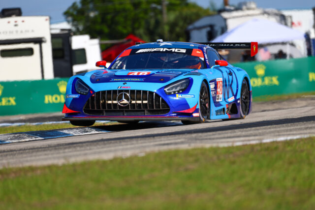 Blue Mercedes-AMG race car #48 speeding on a race track, front view with sponsor decals visible on the hood and sides.